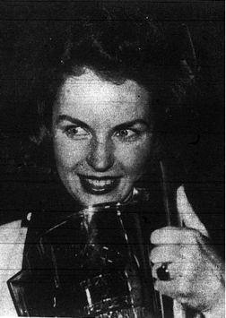 Gleaming with her trophy, Marjorie Carlin celebrates being named 1940 Carival Queen.